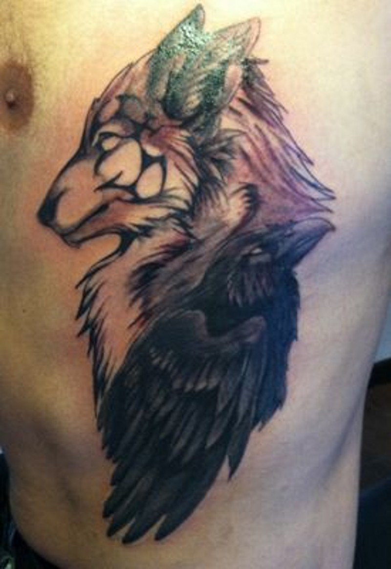 Black Raven And Tribal Wolf Head Tattoo On Man Side Rib