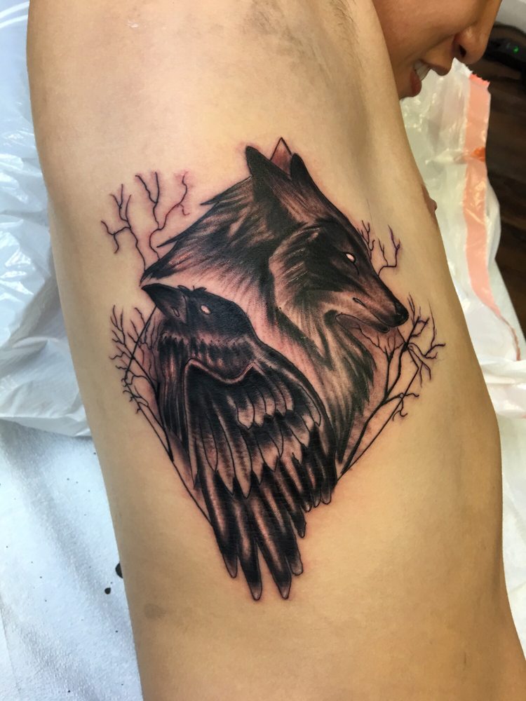 Black Raven And Wolf Head Tattoo On Man Side Rib