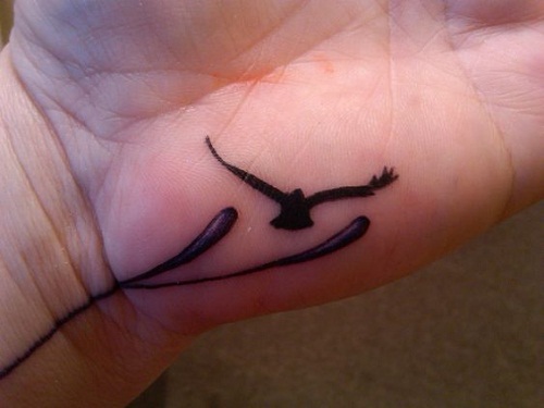 Black Silhouette Small Dove Tattoo On Hand