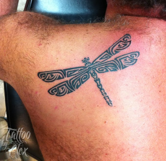 Black Tribal Dragonfly Tattoo On Man Left Back Shoulder