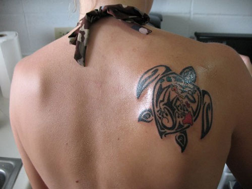 Black Tribal Turtle Tattoo On Girl Right Back Shoulder