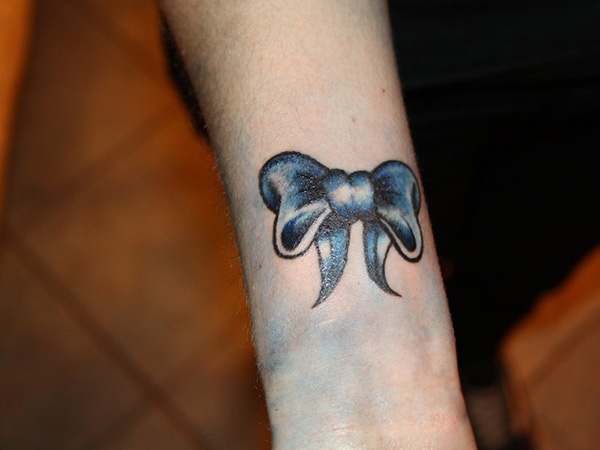 Blue Bow Tattoo On Right Forearm
