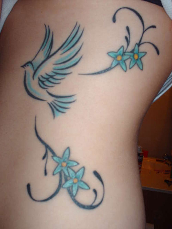 Blue Flowers And Dove Tattoo On Side Rib
