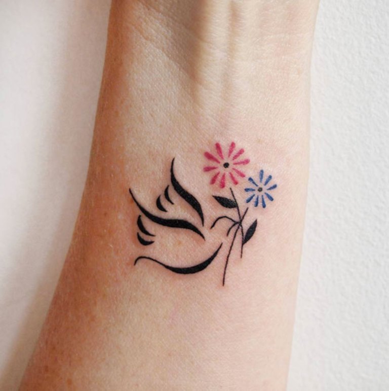 color flowers and dove tattoo ranteeseen kyynärvarteen