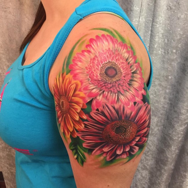 Colored Daisy Flowers Tattoos On Left Shoulder For Women