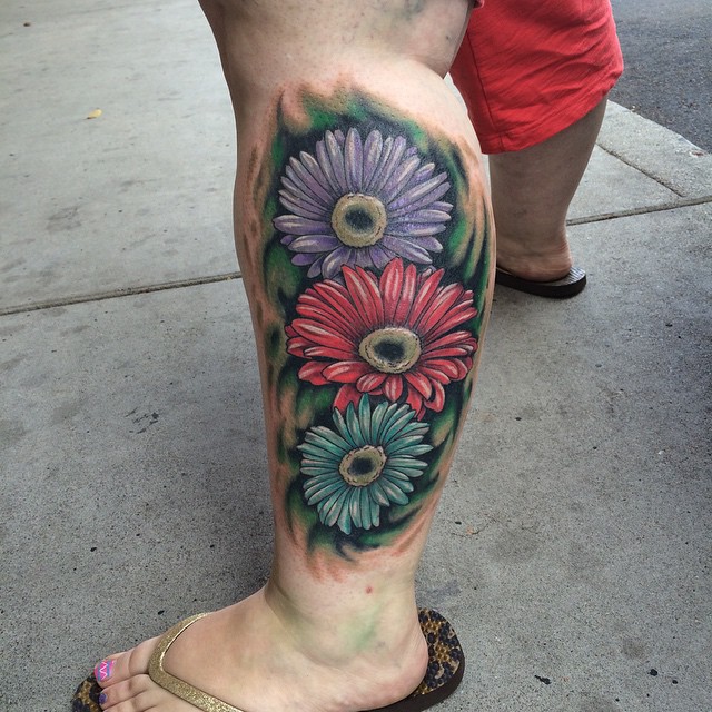 Colored Daisy Flowers Tattoos On Side Leg