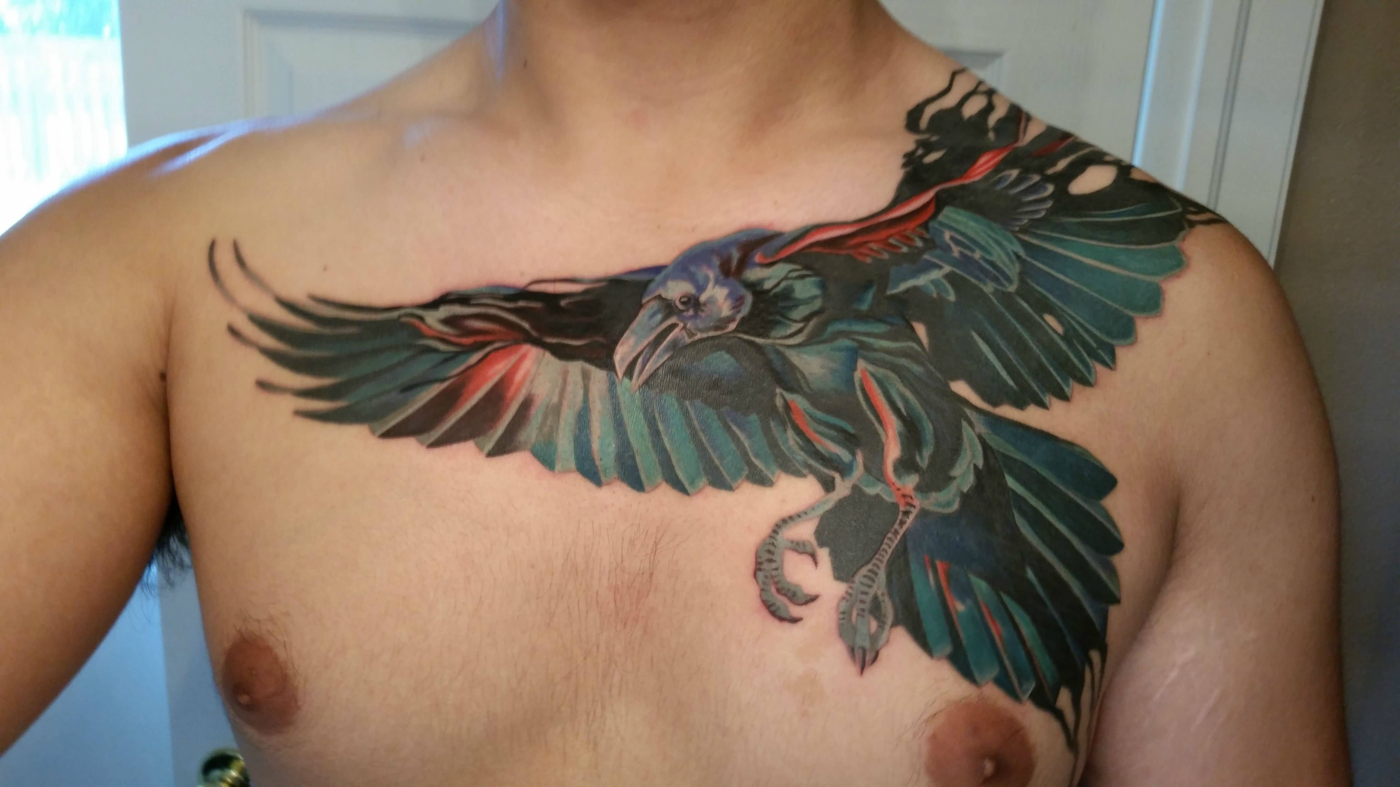 Colored Flying Raven Tattoo On Man Front Shoulder