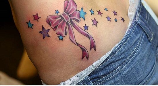 Colored Stars And Bow Tattoo On Lower Back