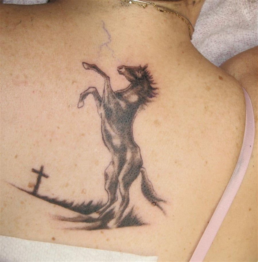 Cross And Black Horse Tattoo On Upper Back