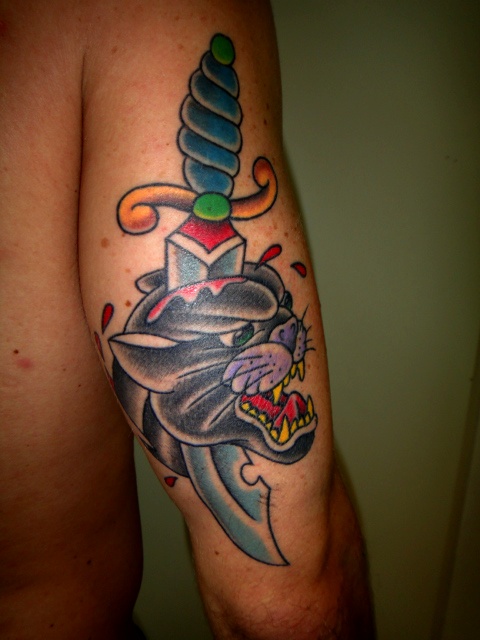 Dagger In Traditional Panther Head Tattoo On Bicep