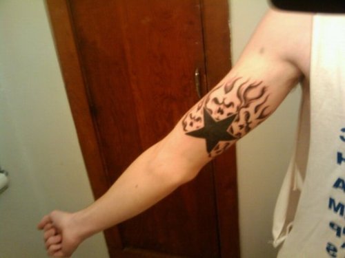Flaming Skull Star Tattoo On Arm Sleeve