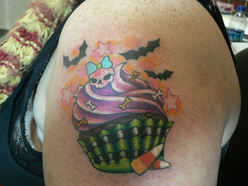 Flying Bats And Cupcake Tattoo On Left Shoulder