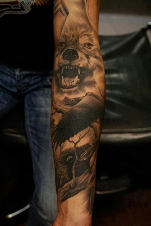 Flying Raven And Grey Wolf Head Tattoo On Left Forearm