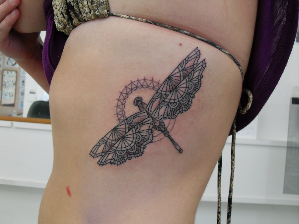Flying Tribal Dragonfly Tattoo On Girl Side Rib
