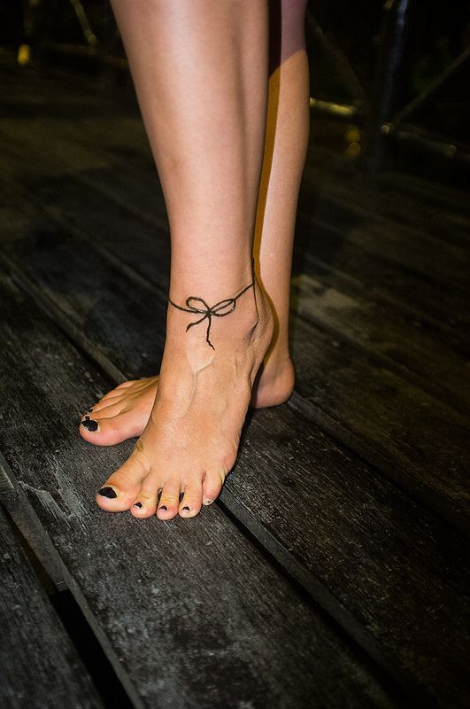Girl With Bow Tattoo On Left Ankle