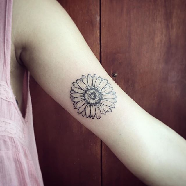 Girl With Daisy Flower Tattoo On Inner Bicep
