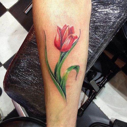 Green And Red Tulip Flower Tattoo On Forearm