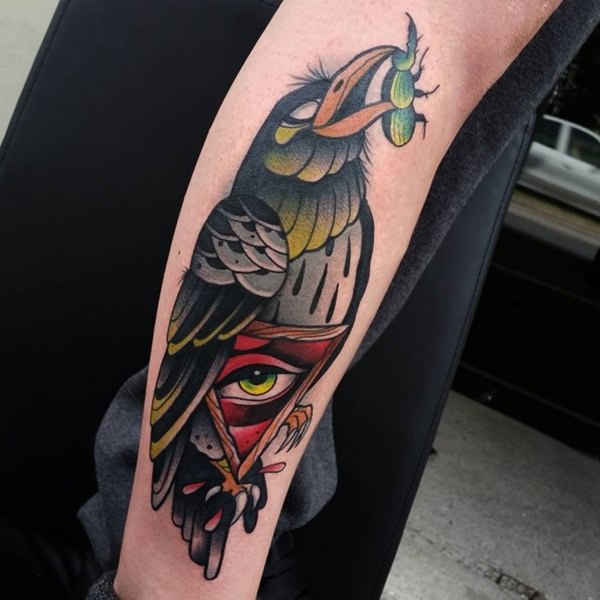 Green Beetle In Raven Beak With Triangle Eye Tattoo On Leg