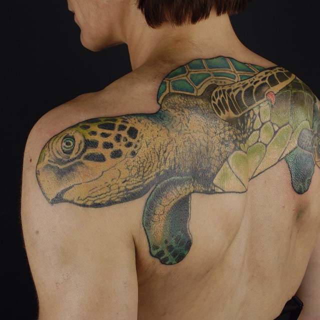 Green Ink Turtle Tattoo On Man Upper Back