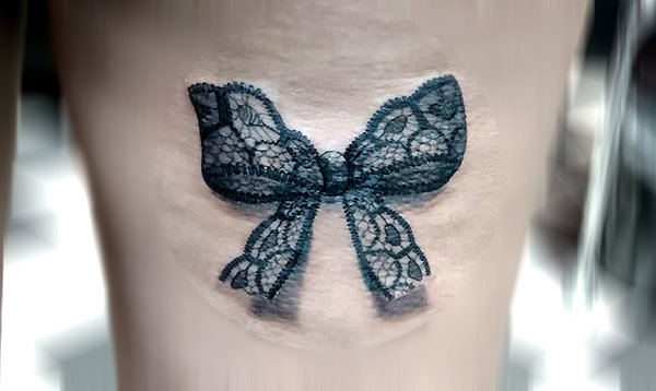 Grey And Black Ink Lace Bow Tattoo On Leg
