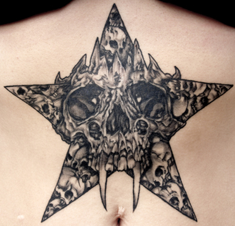 Grey And Black Skulls With Star Tattoo On Belly