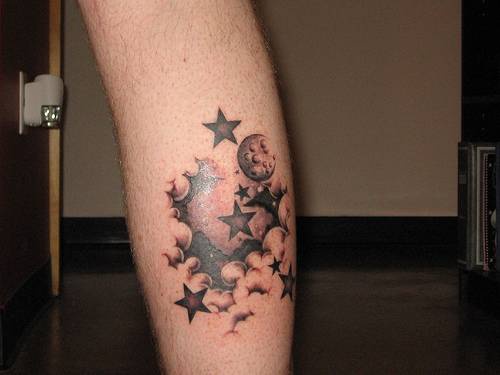 Grey And Black Stars And Clouds Tattoo On Back Leg