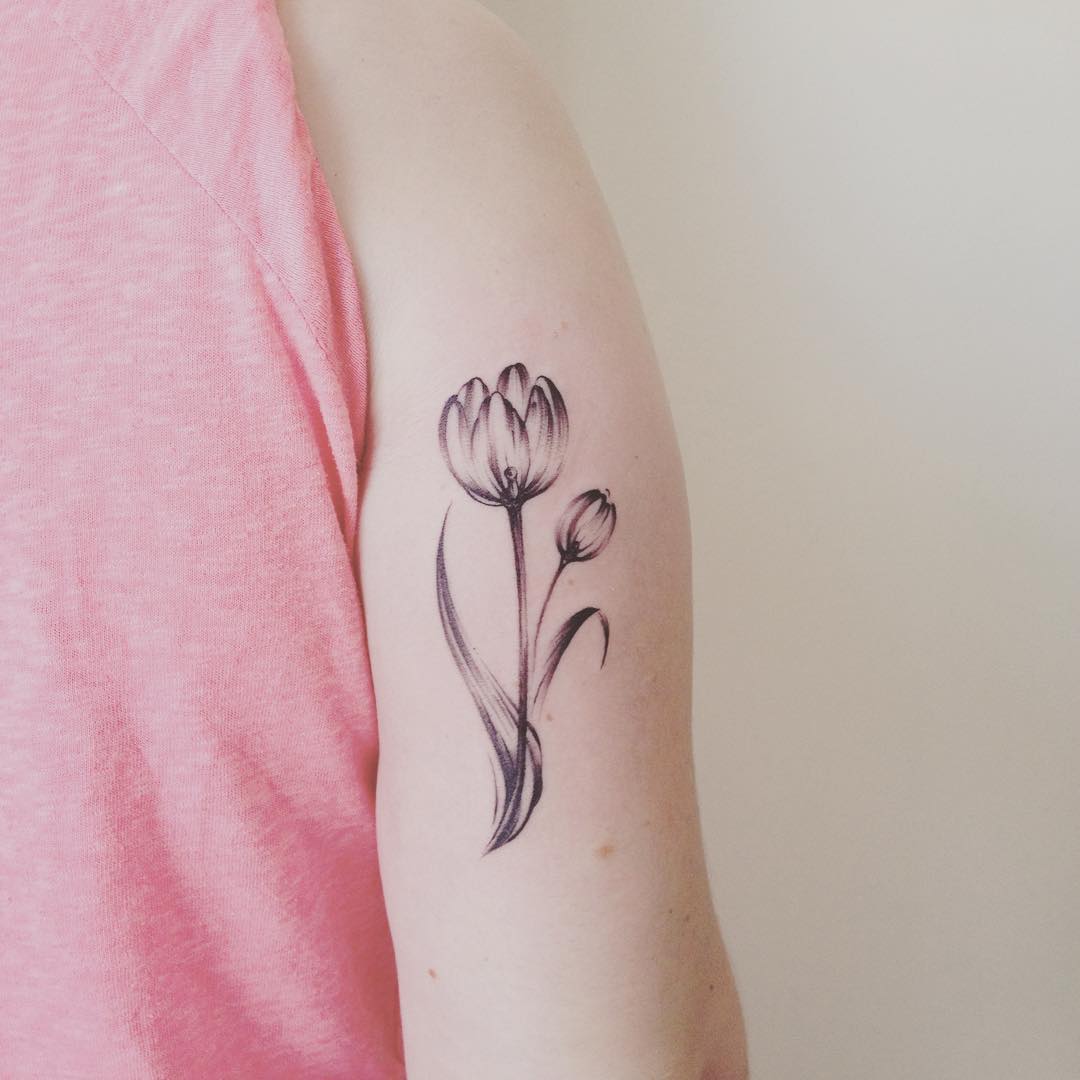 Grey And White Tulip Flower Tattoo On Bicep