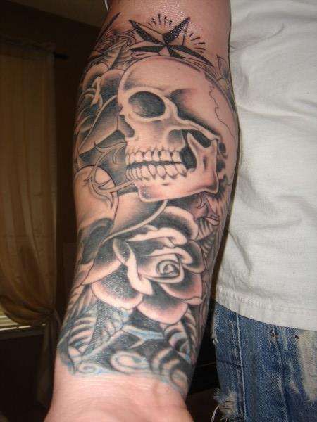 Grey Flowers And Skull With Nautical Star Tattoo On Right Forearm