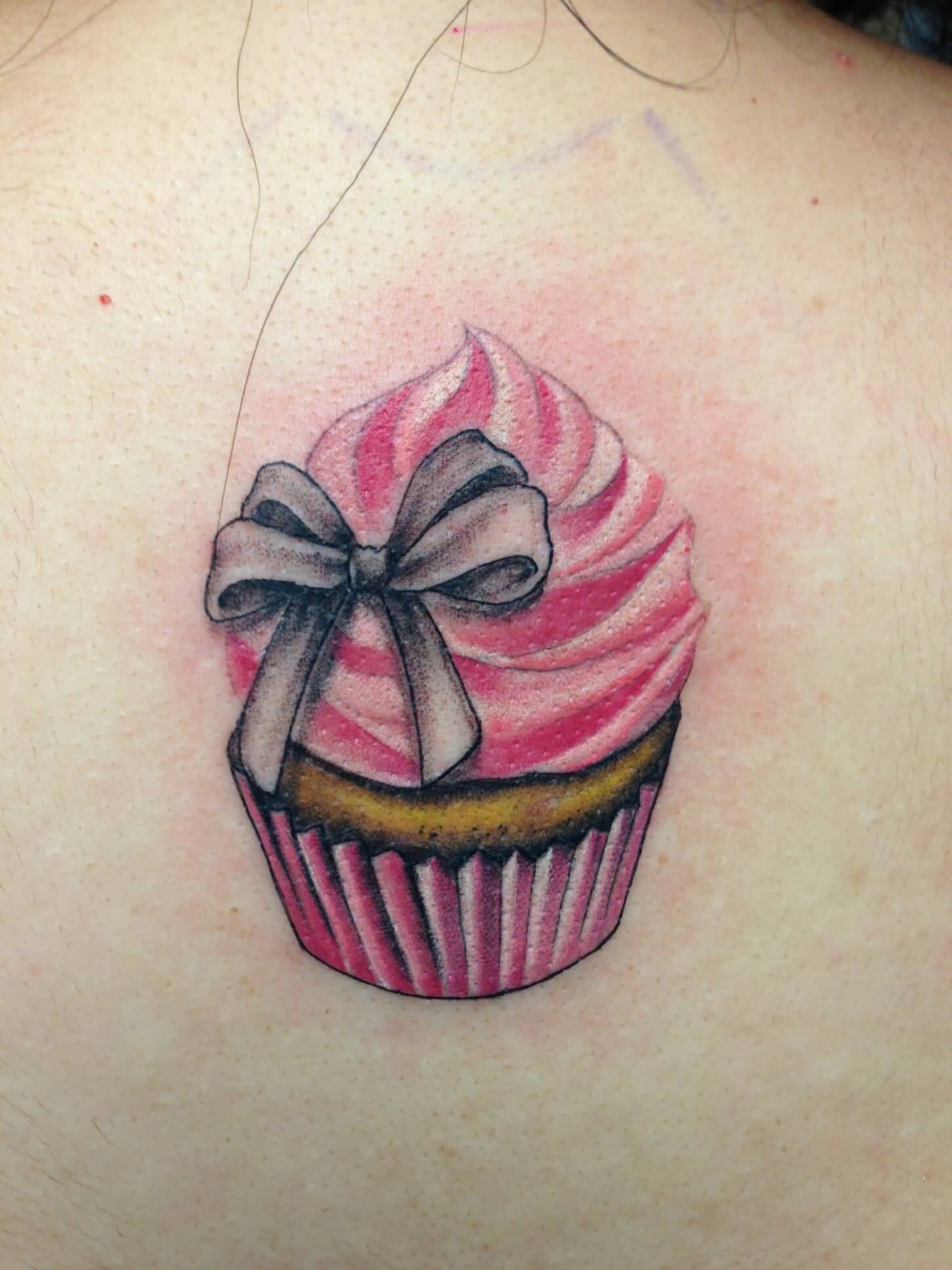 Grey Ink Bow On Cupcake Tattoo On Back