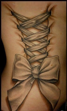 Grey Ink Corset Bow Tattoo On Side Rib