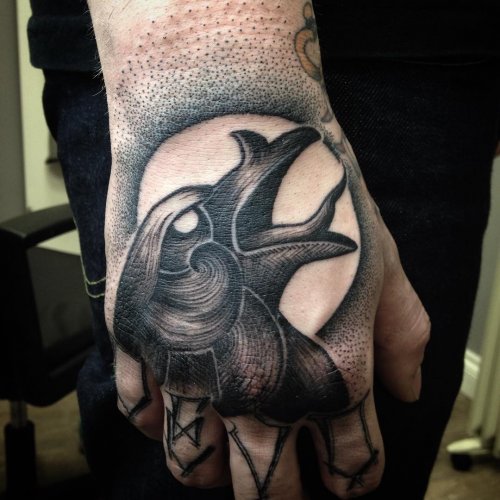 Grey Ink Raven Head Tattoo On Right Hand