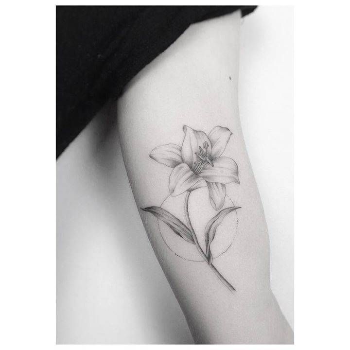 Grey Ink Small Lily Tattoo On Bicep