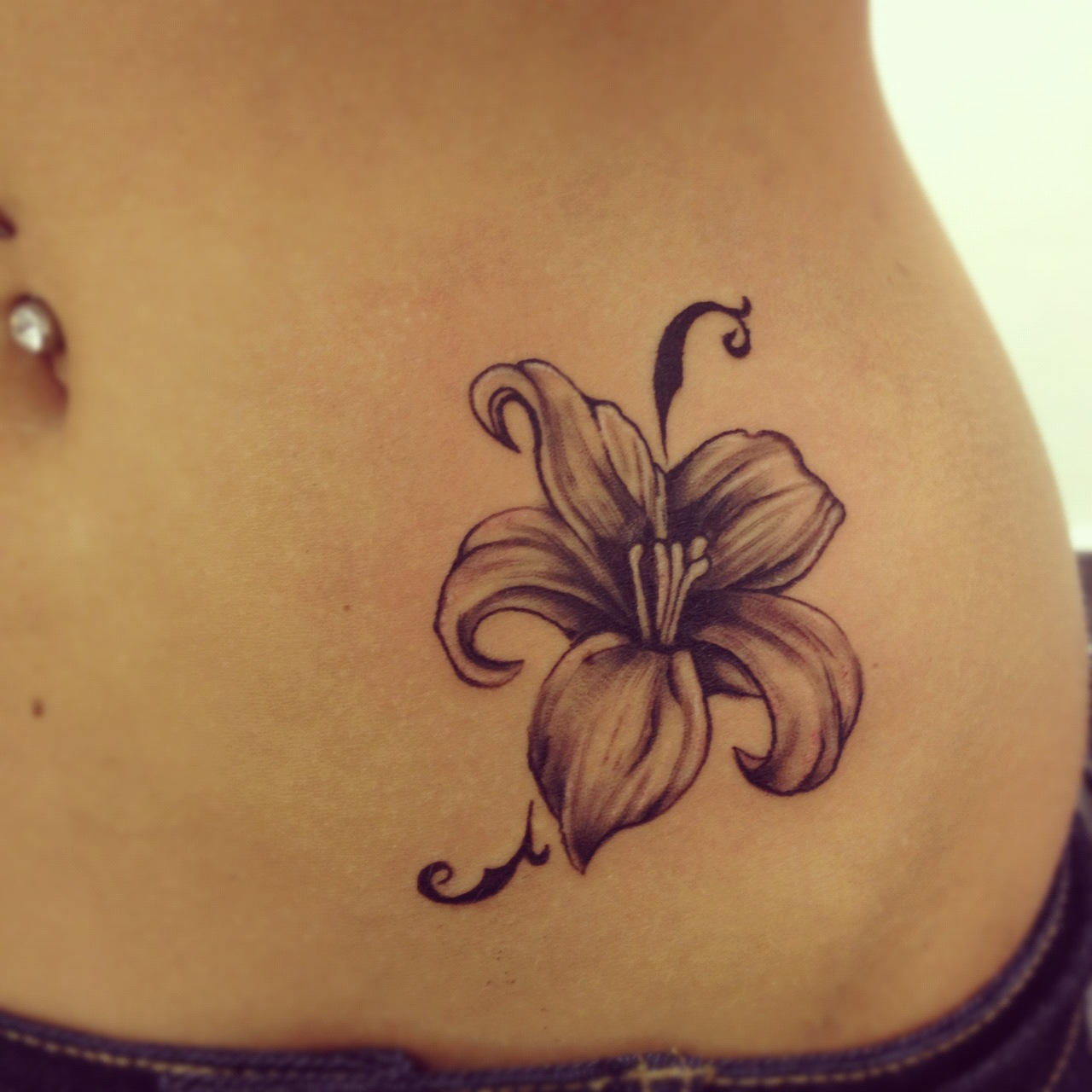 Grey Ink Small Lily Tattoo On Hip