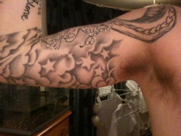 Grey Ink Stars and Clouds Tattoo On Bicep
