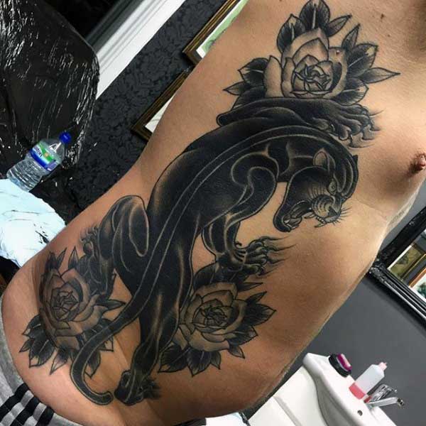 Grey Roses And Traditional Panther Tattoo On Man Rib Side