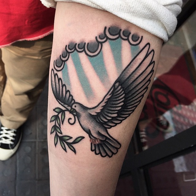 Guy With Flying Peace Dove Tattoo On Left Forearm
