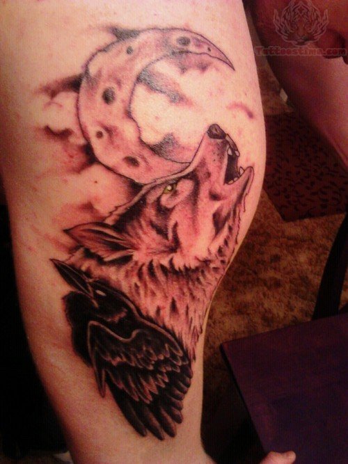 Half Moon With Howling Wolf And Raven Tattoo On Leg