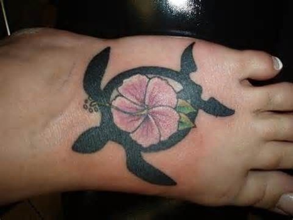 Hawaiian Flower In Turtle Tattoo On Left Foot