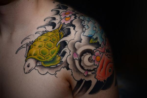 Japanese Flowers And Sea Turtle Tattoo On Man Left Shoulder