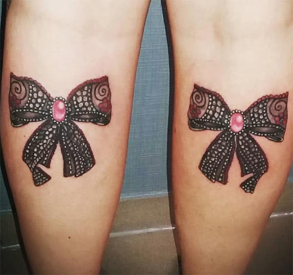 Bow tattoos on back of thighs