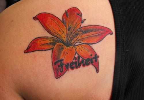 Left Back Shoulder Freiheit Lily Flower Tattoo