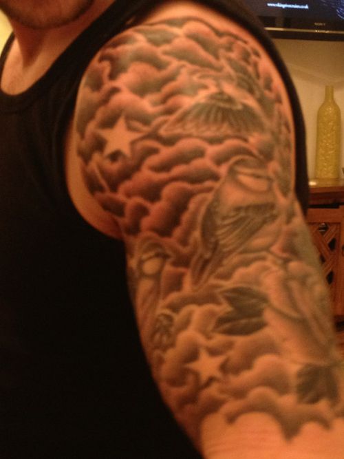 Man With Clouds And Stars Tattoo On Left Half Sleeve