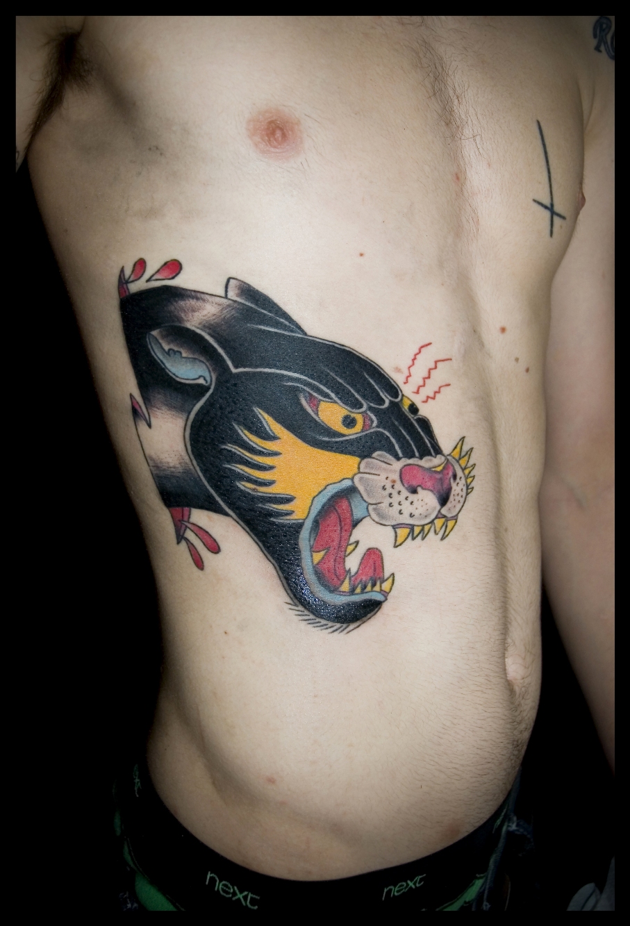 Man With Ripped Skin Panther Head Tattoo on Side Rib