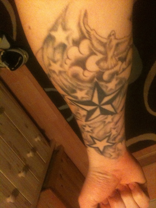 Nautical Star And Clouds Tattoo On Forearm