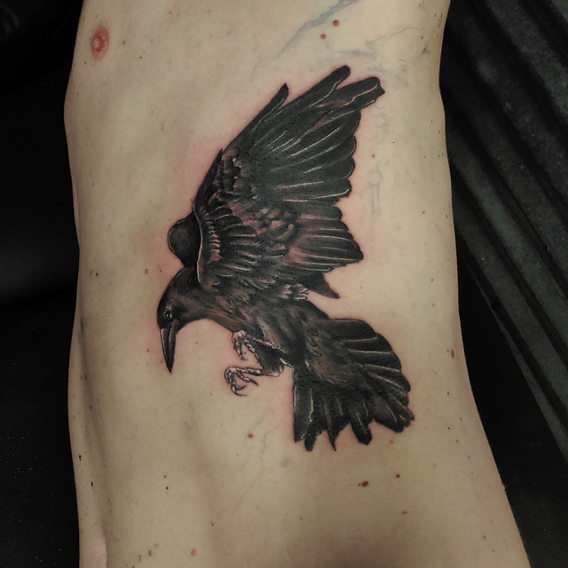 Nice Flying Raven Tattoo On Man Rib Side