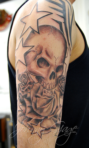 Nice Grey Ink Skull With Rose And Star Tattoo by Johnny Gage