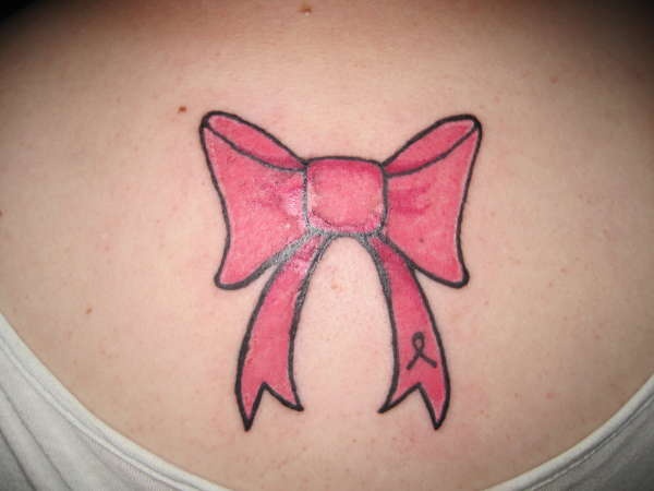 Nice Pink Bow Tattoo On Girl Upper Back