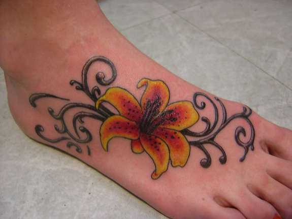 Orange And Yellow Ink Tattoo On Right Foot