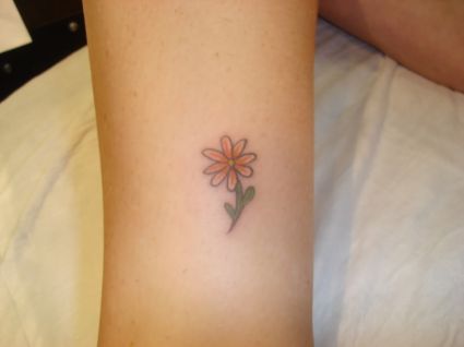 Orange Small Daisy Tattoo On Leg