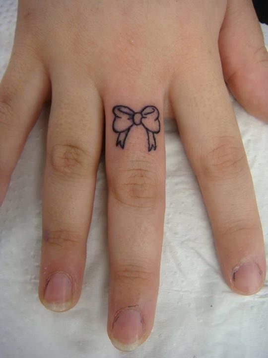 Outline Bow Tattoo On Middle Finger